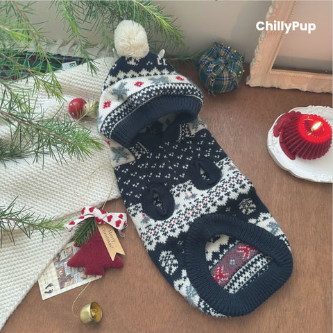 Knitted dog hoody with reindeer pattern on a wooden surface, branded 'ChillyPup'.